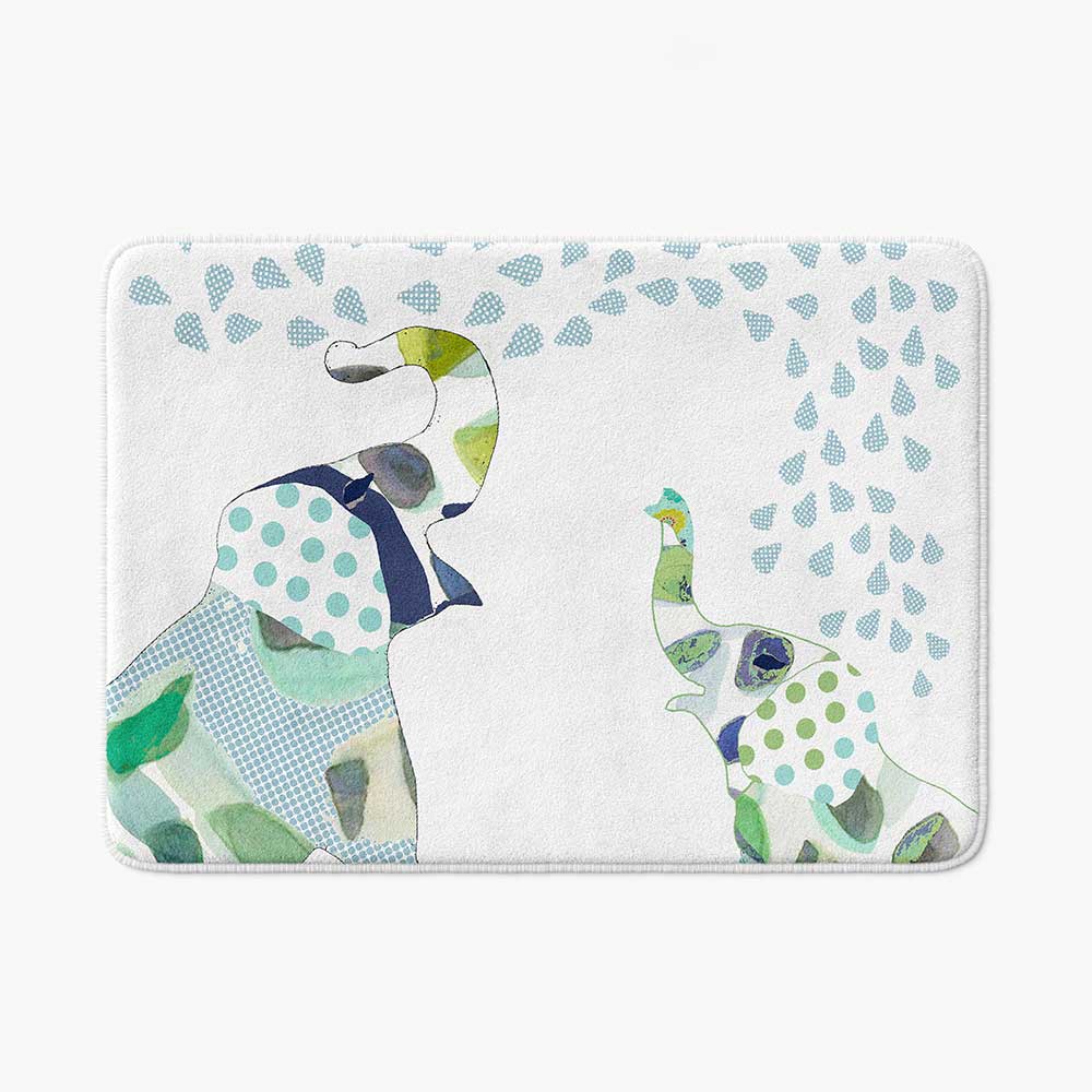 A white microfiber non slip bath mat for kids featuring a playful blue and green elephant print. Mold and mildew resistant, plush, soft, non-slip, machine washable, and quick drying.