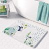 A white microfiber non slip bath mat for kids featuring a playful blue and green elephant print. Mold and mildew resistant, plush, soft, non-slip, machine washable, and quick drying.