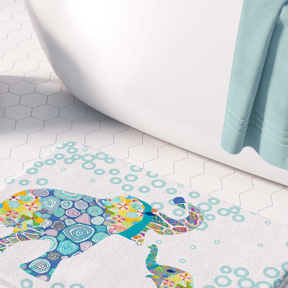 A white microfiber non slip bath mat for toddler boys featuring a charming blue elephant print. Mold and mildew resistant, plush, soft, non-slip, machine washable, and quick drying.