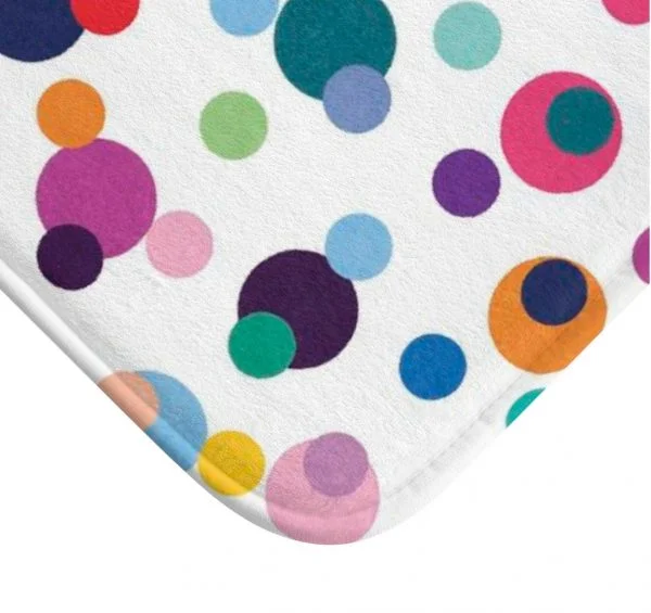 Close-up of multi-colored polka dot print on Ozscape Designs kids bath mat.