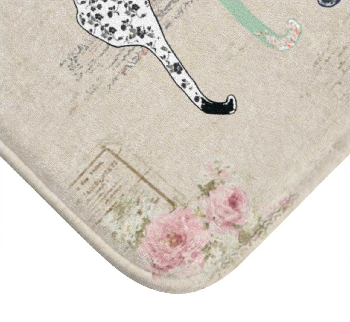 Close-up of a beige and pink rose floral design on a cat bath mat.