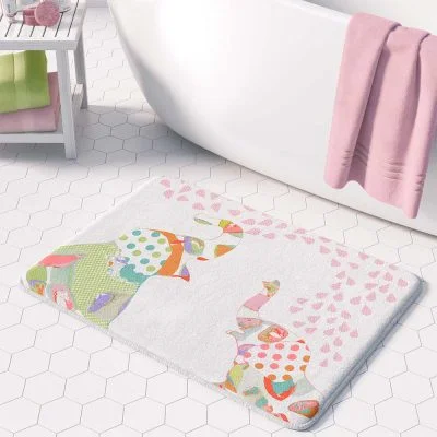 A white microfiber non slip bath mat for kids featuring a playful pink and green elephant print. Mold and mildew resistant, plush, soft, machine washable, and quick drying.