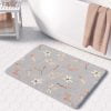 A grey floral boho bathroom mat, perfect for adding a touch of bohemian elegance to any bathroom. Mold and mildew resistant, quick-drying, non-slip plush microfiber, washable.