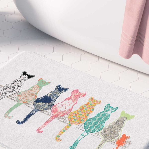 White bath mat adorned with floral cats pattern