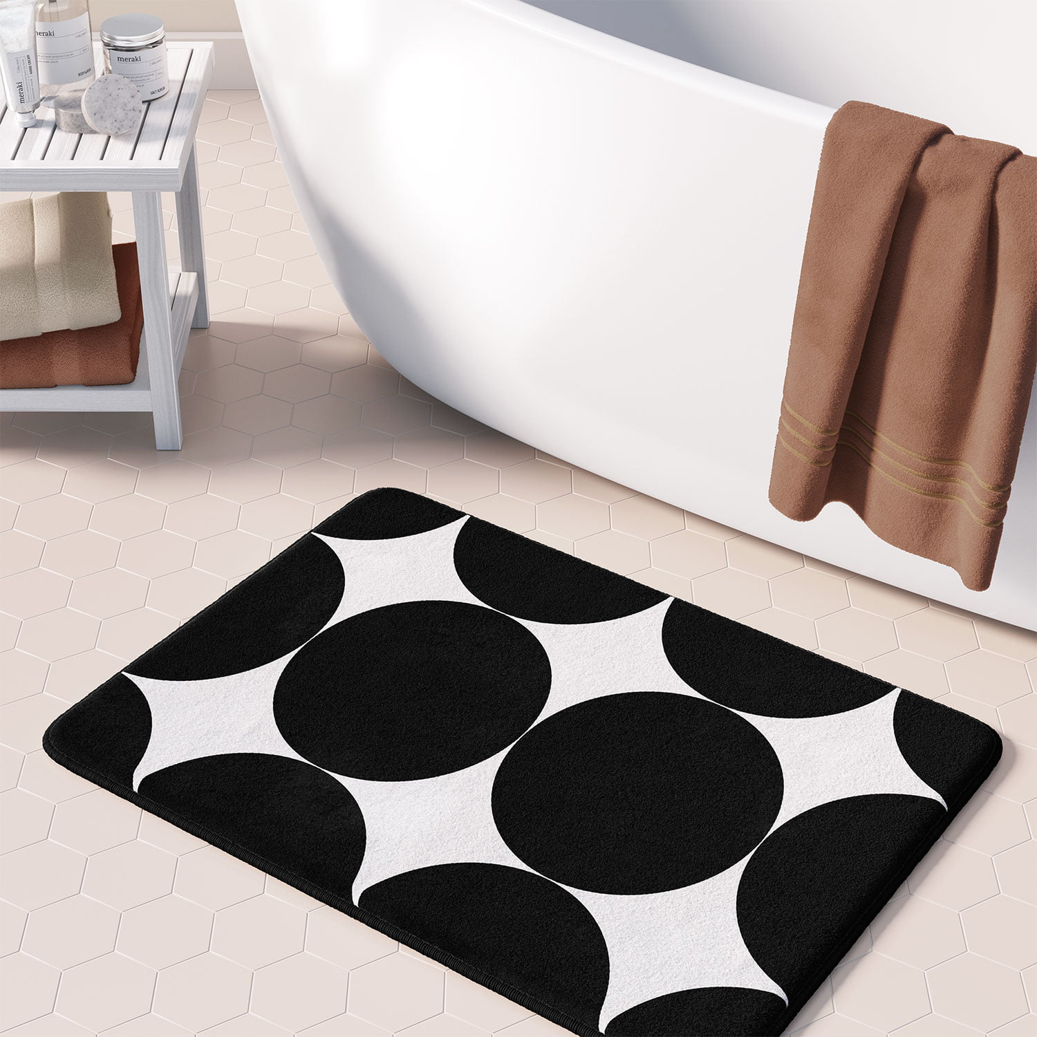 Black and white patterned bath mat with big bold black circles.