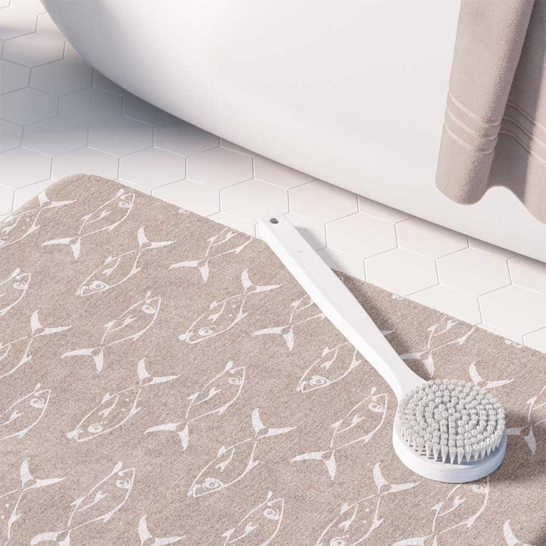 Beige non-slip bath mat featuring white trevally fish design."
