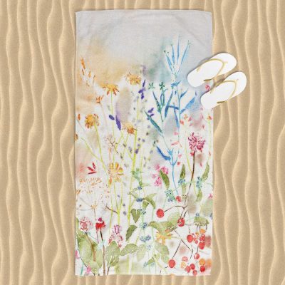 Colorful wildflower floral patterned beach towel with velour front and cotton terry back.