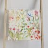 Colorful wildflower floral patterned hand towel with velour front and cotton terry back.