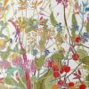 Close-up view of the vibrant colorful wildflower floral artwork patterned on the towel's velour front.