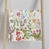 Colorful wildflower floral patterned hand towel with velour front and cotton terry back.