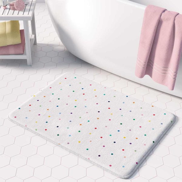 A girls' bathroom bath mat featuring tiny colorful polka dots