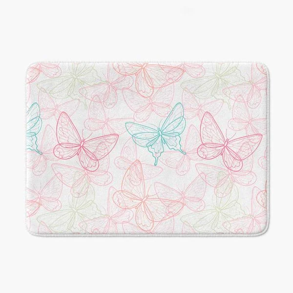 Pink butterfly bath mat for kids with soft memory foam and non-slip backing on white bathroom floor