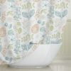 A nature inspired botanical printed fabric shower curtain for a farmhouse bathroom