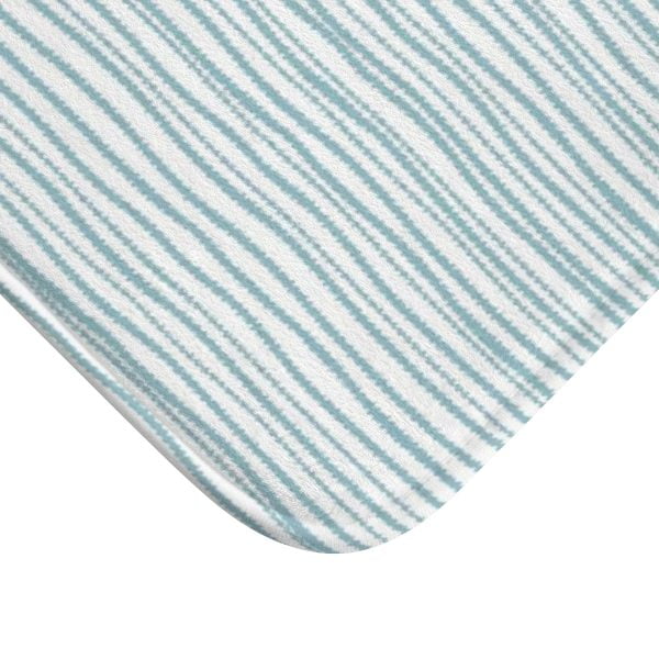 A coastal blue striped bath mat perfect for a small bathroom, master, or guest bathroom. Mold and mildew resistant, quick-drying, non-slip plush microfiber, washable.