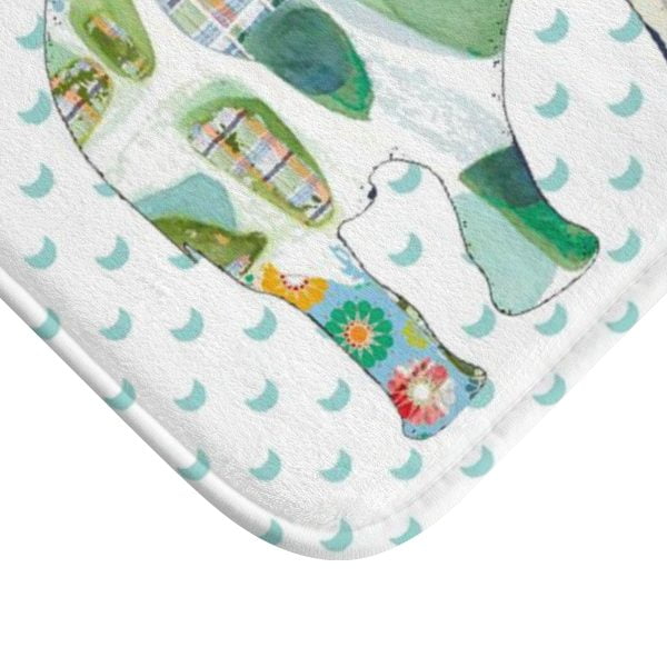 A white microfiber non slip bath mat for kids featuring a playful blue and green elephant print. Mold and mildew resistant, plush, soft, non-slip, machine washable, and quick drying.