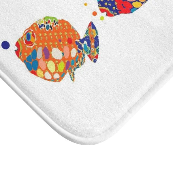 A colorful kids bath mat adorned with vibrant fish patterns, perfect for a kids' bathroom. Mold and mildew resistant, quick-drying, non-slip plush microfiber, washable.