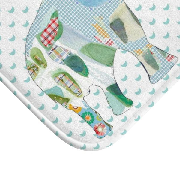 A white microfiber non slip bath mat for kids featuring a playful blue and green elephant print. Mold and mildew resistant, plush, soft, non-slip, machine washable, and quick drying.