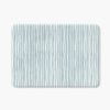 A coastal blue striped bath mat perfect for a small bathroom, master, or guest bathroom. Mold and mildew resistant, quick-drying, non-slip plush microfiber, washable.