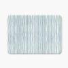 A coastal blue striped bath mat perfect for a small bathroom, master, or guest bathroom. Mold and mildew resistant, quick-drying, non-slip plush microfiber, washable.