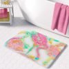 A vibrant pink flamingo tropical bathroom bath mat, perfect for adding a touch of tropical flair to any bathroom. Mold and mildew resistant, quick-drying, non-slip plush microfiber, washable.