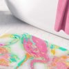 A vibrant pink flamingo tropical bathroom bath mat, perfect for adding a touch of tropical flair to any bathroom. Mold and mildew resistant, quick-drying, non-slip plush microfiber, washable.