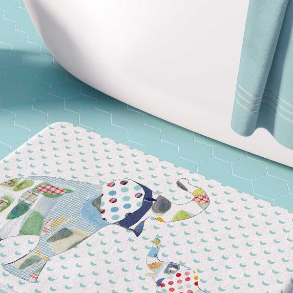 A white microfiber non slip bath mat for kids featuring a playful blue and green elephant print. Mold and mildew resistant, plush, soft, non-slip, machine washable, and quick drying.