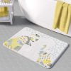 A kids bath mat featuring a charming grey and yellow elephant print, perfect for a kids' bathroom. Mold and mildew resistant, quick-drying, non-slip plush microfiber, washable.