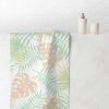 Hand towel with abstract tropical apricot palm leaves pattern.