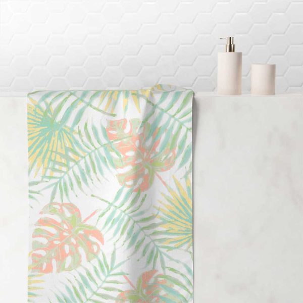Hand towel with abstract tropical apricot palm leaves pattern.