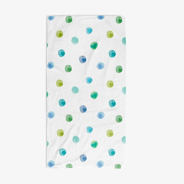 Full view of a white cotton polyester velour bath towel with blue and green watercolor polka dots.