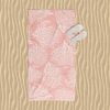 Beach towel with elegant tropical coral pink pattern.