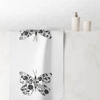Hand towel with black and white abstract butterfly print, perfect for a modern girls' bathroom.