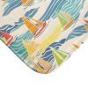 close-up of microfiber fabric on beach-themed bath mat with blue and yellow sailboats