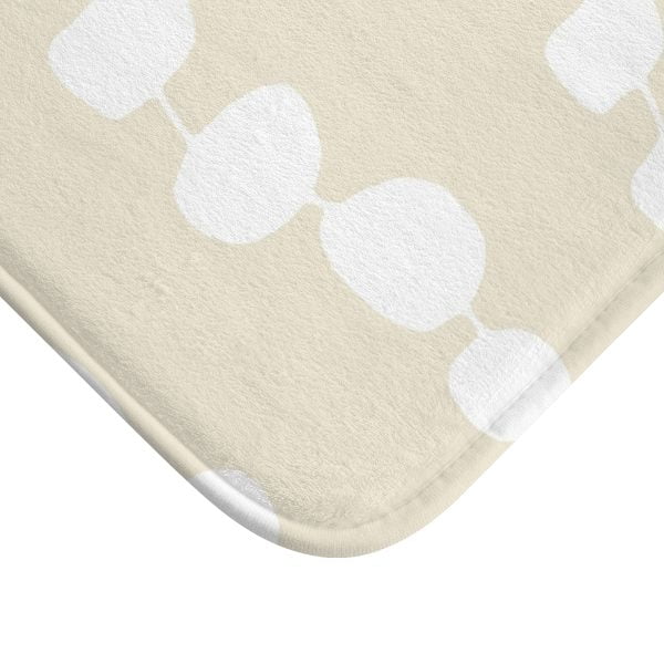 Close-up view of the microfiber texture on the coastal beige and white pebble striped designer non-slip bath mat.