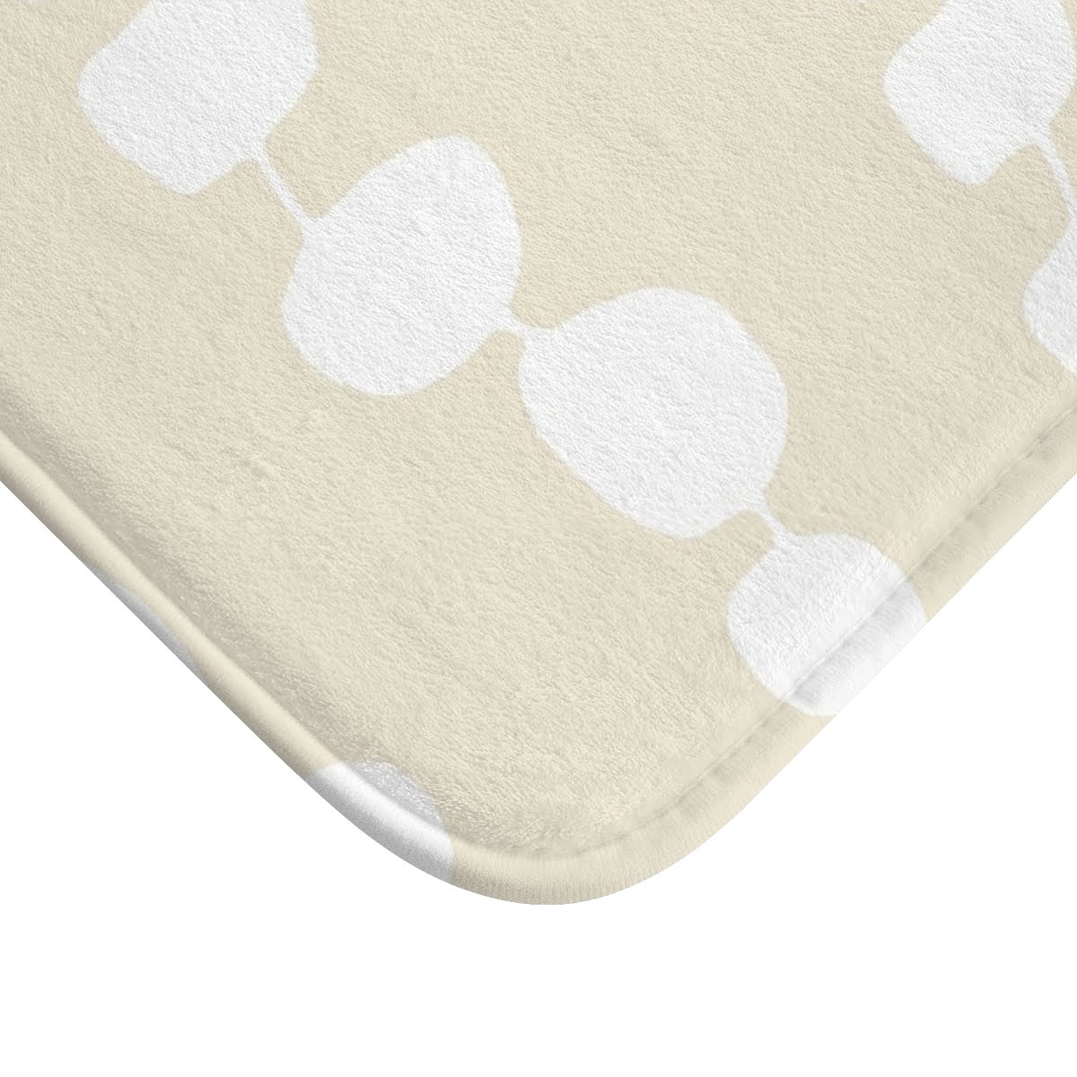 Close-up view of the microfiber texture on the coastal beige and white pebble striped designer non-slip bath mat.