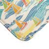 close-up of microfiber fabric on beach-themed bath mat with blue and yellow sailboats