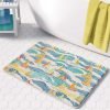 microfiber beach-themed bath mat with blue and yellow sailboats in bathroom