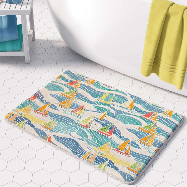 microfiber beach-themed bath mat with blue and yellow sailboats in bathroom