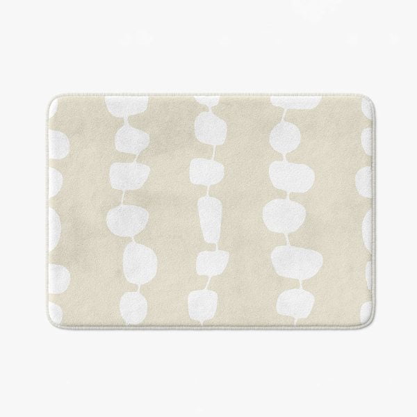 Full view of the elegant coastal beige and white pebble striped designer microfiber non-slip bath mat.