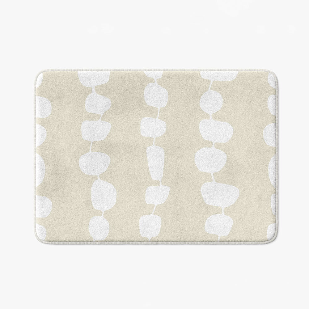 Full view of the elegant coastal beige and white pebble striped designer microfiber non-slip bath mat.