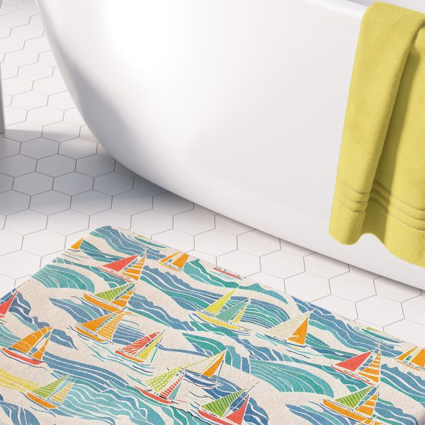 microfiber beach-themed bath mat with blue and yellow sailboats in bathroom
