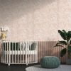 Peachy pink watercolor leaf neutral wallpaper in a baby nursery