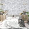 Grey watercolor leaf neutral wallpaper in a bedroom