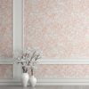 Elegant peach blush pink watercolor leaf peel and stick wallpaper in a serene bedroom