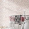 Peachy pink watercolor leaf neutral wallpaper in a baby nursery