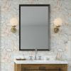 Dinosaur wallpaper in modern contemporary design with orange, gray, blue, mustard, and white colors in a kids bathroom.