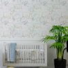 Contemporary grey, green, yellow and white elephant wallpaper in a baby nursery