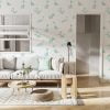 Mint green dinosaur wallpaper in a kids room, available in vinyl, paper, or fabric peel and stick options