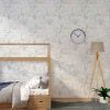 Modern grey, green, mustard and white elephant wallpaper in a kids room
