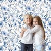Gentle blue watercolor floral wallpaper in a baby playroom